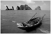 Boat and limestone towers, undeveloped beach. Hong Chong Peninsula, Vietnam (black and white)