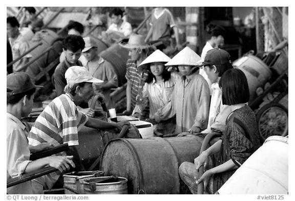 Filling up water tanks for the day. Ha Tien, Vietnam