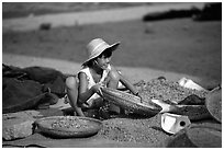 Girl sorting dried shrimp. Ha Tien, Vietnam (black and white)