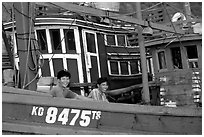 Fishermen on a commercial fishing boat. Ha Tien, Vietnam (black and white)