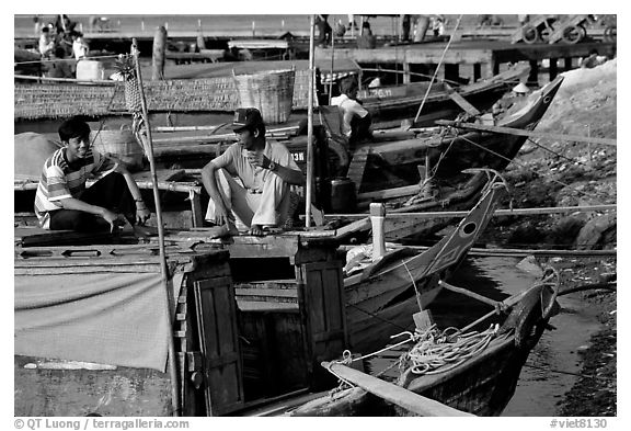 Boats from the delta waterways meet the sea. The pinapple on the pole serves to signal the boat cargo to others. Ha Tien, Vietnam (black and white)