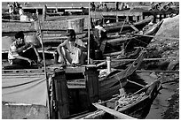 Boats from the delta waterways meet the sea. The pinapple on the pole serves to signal the boat cargo to others. Ha Tien, Vietnam ( black and white)