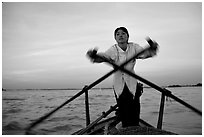 Woman using the X-shaped  paddle characteristic of the Delta. Can Tho, Vietnam (black and white)