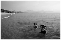 Early morning bath on a perfect beach Nha Trang. Vietnam (black and white)