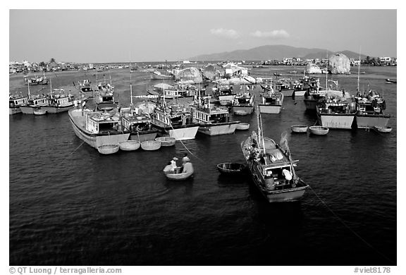Colorfull fishing boats. Note the circular basket boats used to get to shore.  Nha Trang. Vietnam (black and white)