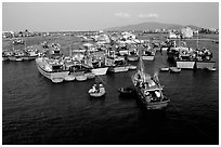 Colorfull fishing boats. Note the circular basket boats used to get to shore.  Nha Trang. Vietnam (black and white)