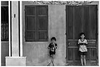 Children in front of old house, Hoi An. Hoi An, Vietnam ( black and white)