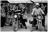 Flower Hmong women getting a ride on all-terrain russian-made motorbikes to the sunday market. Bac Ha, Vietnam (black and white)