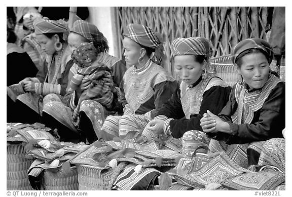 Women sell the colorful garnments after which the Flower Hmong are named. Bac Ha, Vietnam