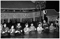 Artists salute after a water puppets performance in 1999. Hanoi, Vietnam (black and white)