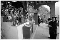 Praying at an outdoor temple. Perfume Pagoda, Vietnam (black and white)