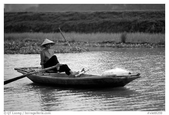 The local technique of paddling with feet, Ken Ga canal. Ninh Binh,  Vietnam (black and white)