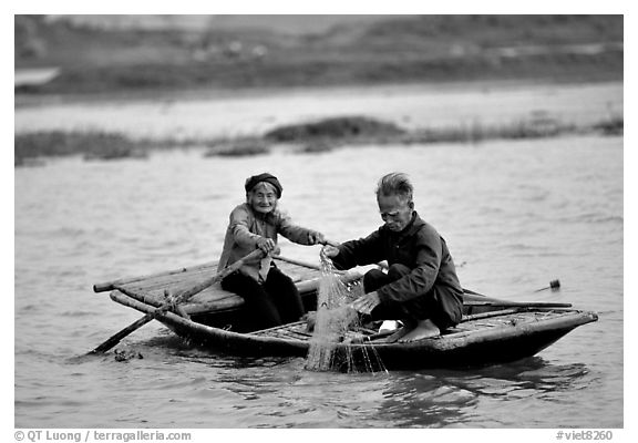 Elderly couple fishing, Ken Ga canal. Ninh Binh,  Vietnam (black and white)