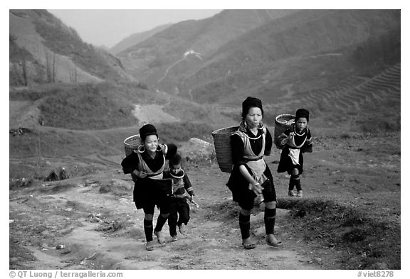 Hmong women returning to their village, which cannot be reached by the road. Sapa, Vietnam (black and white)