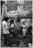 Hairdressing in the street. Ho Chi Minh City, Vietnam (black and white)