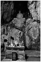 Altar and Buddha statue in a troglodyte sanctuary of the Marble Mountains. Da Nang, Vietnam (black and white)