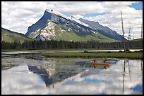 Canoe and Mt Rundle reflection in first Vermillion Lake, afternon. Banff National Park, Canadian Rockies, Alberta, Canada