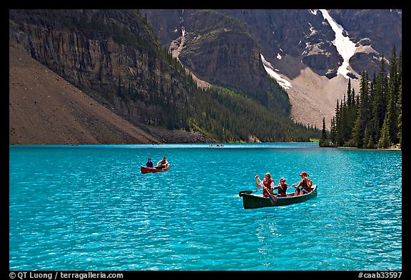 Canoes on the robbin egg blue Moraine Lake, afternoon. Banff National Park, Canadian Rockies, Alberta, Canada