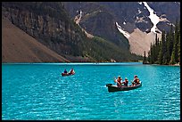 Canoes on the robbin egg blue Moraine Lake, afternoon. Banff National Park, Canadian Rockies, Alberta, Canada