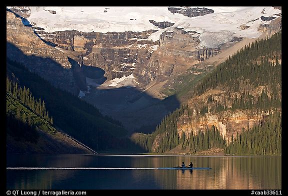 Rowers on Lake Louise, below Victoria Glacier, early morning. Banff National Park, Canadian Rockies, Alberta, Canada