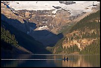 Rowers on Lake Louise, below Victoria Glacier, early morning. Banff National Park, Canadian Rockies, Alberta, Canada