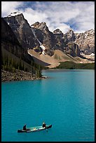 Canoeists below  Wenkchemna Peaks, Moraine Lake, mid-morning. Banff National Park, Canadian Rockies, Alberta, Canada