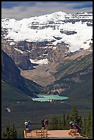 Tourists at observation platform, looking at  Lake Louise and  Victoria Peak. Banff National Park, Canadian Rockies, Alberta, Canada (color)