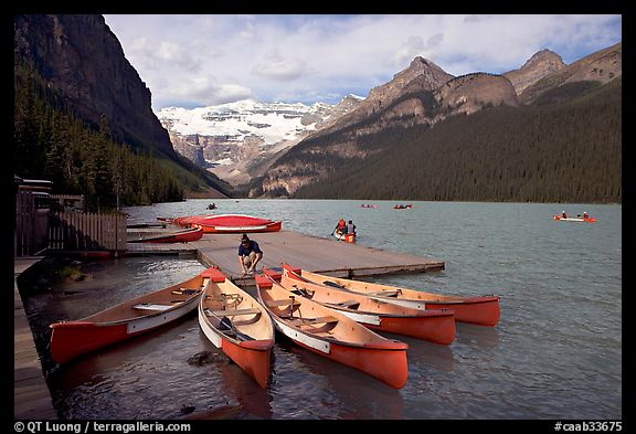 Red canoes at boat dock, Lake Louise, morning. Banff National Park, Canadian Rockies, Alberta, Canada