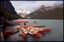 Red canoes at boat dock, Lake Louise, morning. Banff National Park, Canadian Rockies, Alberta, Canada