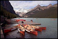 Red canoes at boat dock, Lake Louise, morning. Banff National Park, Canadian Rockies, Alberta, Canada (color)