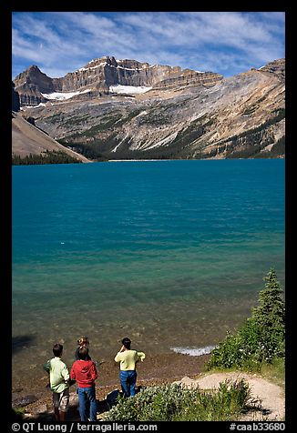 Family standing on the shores of Bow Lake. Banff National Park, Canadian Rockies, Alberta, Canada (color)