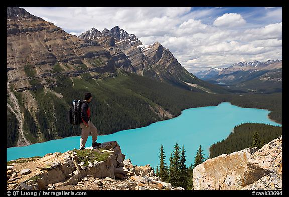 Hiker standing on a rock overlooking Peyto Lake. Banff National Park, Canadian Rockies, Alberta, Canada (color)