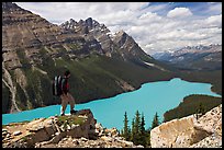 Hiker standing on a rock overlooking Peyto Lake. Banff National Park, Canadian Rockies, Alberta, Canada