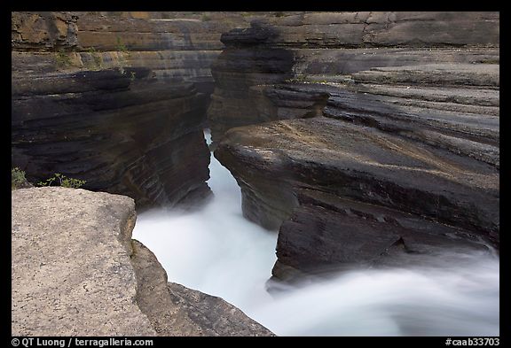 River flowing through narrow rock gorge, Mistaya Canyon. Banff National Park, Canadian Rockies, Alberta, Canada