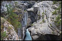 Narrow slot cut in limestone rock by river, Mistaya Canyon. Banff National Park, Canadian Rockies, Alberta, Canada