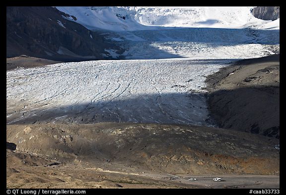 Base of Athabasca Glacier with cars parked on lot. Jasper National Park, Canadian Rockies, Alberta, Canada (color)