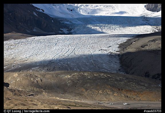 Base of Athabasca Glacier with cars parked on lot. Jasper National Park, Canadian Rockies, Alberta, Canada