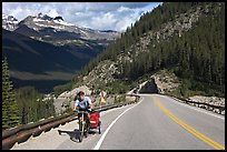 Cyclist with tow, Icefieds Parkway. Jasper National Park, Canadian Rockies, Alberta, Canada