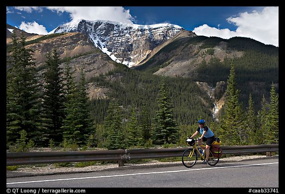 Woman cycling the Icefields Parkway. Jasper National Park, Canadian Rockies, Alberta, Canada