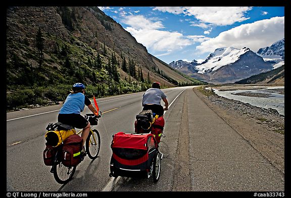 Couple cycling the Icefields Parkway. Jasper National Park, Canadian Rockies, Alberta, Canada (color)