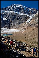 Hikers on trail below the face of Mt Edith Cavell. Jasper National Park, Canadian Rockies, Alberta, Canada