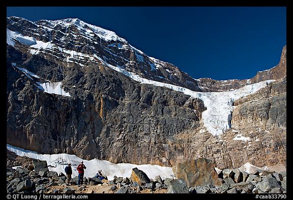 Hikers on a moraine below Mt Edith Cavell, morning. Jasper National Park, Canadian Rockies, Alberta, Canada