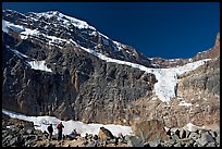 Hikers on a moraine below Mt Edith Cavell, morning. Jasper National Park, Canadian Rockies, Alberta, Canada ( color)