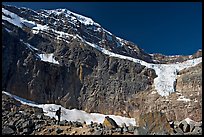 Hiker on a moraine below Mt Edith Cavell and Angel Glacier. Jasper National Park, Canadian Rockies, Alberta, Canada (color)