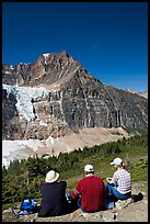 Hikers sitting in front of Mt Edith Cavell next to trail. Jasper National Park, Canadian Rockies, Alberta, Canada ( color)