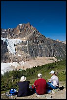 Hikers sitting in front of Mt Edith Cavell next to trail. Jasper National Park, Canadian Rockies, Alberta, Canada