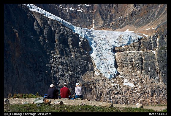 Hikers looking at a hanging glacier on  Mt Edith Cavell. Jasper National Park, Canadian Rockies, Alberta, Canada