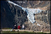 Hikers looking at a hanging glacier on  Mt Edith Cavell. Jasper National Park, Canadian Rockies, Alberta, Canada ( color)
