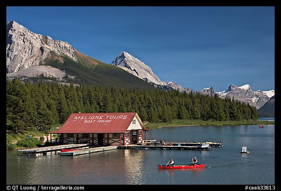 Boat house and canoe beneath Leh and Samson Peaks,  Maligne Lake. Jasper National Park, Canadian Rockies, Alberta, Canada (color)