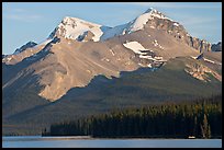 Canoe dwarfed by the Mt Charlton and Mt Unwin surrounding Maligne Lake. Jasper National Park, Canadian Rockies, Alberta, Canada (color)